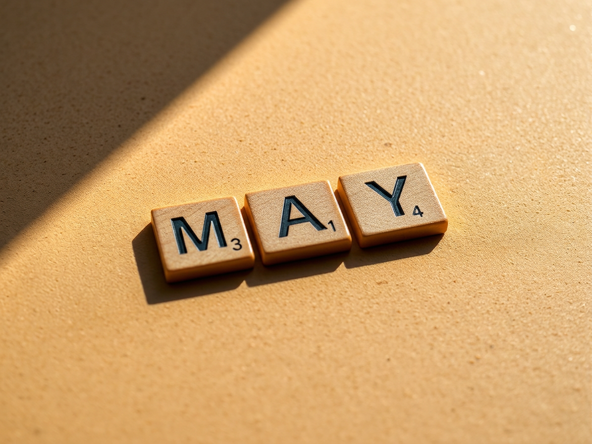 Scrabble tiles spelling the word MAY with scores 3, 1, and 4